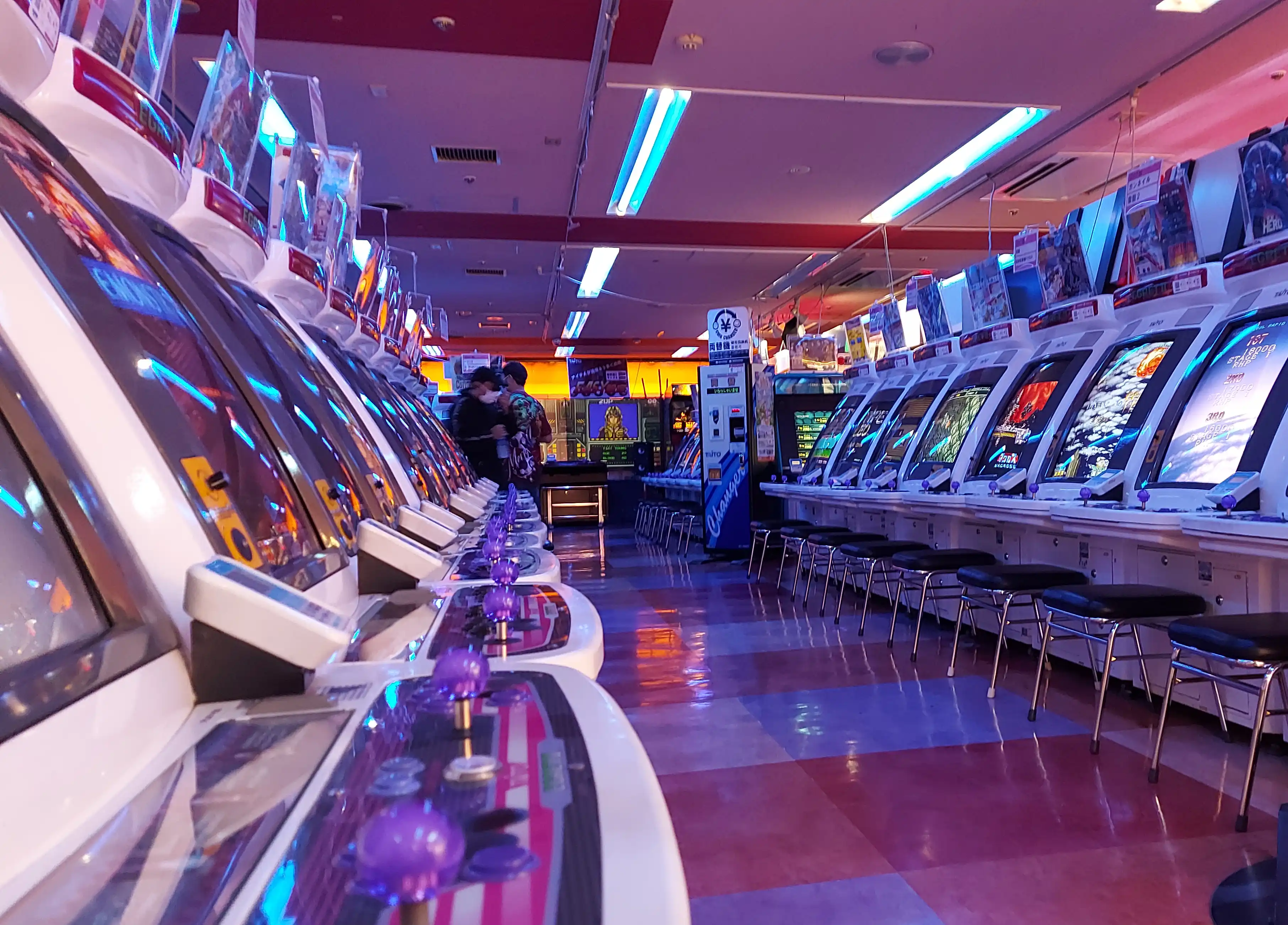 The interior of Taito HEY in Akihabara. Rows of shmup cabinets face each other. Heaven.